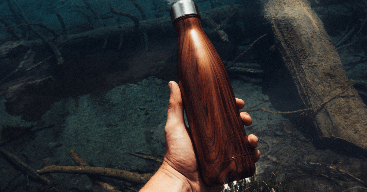 Hand Holding a Wood Grain Thermal Water Bottle