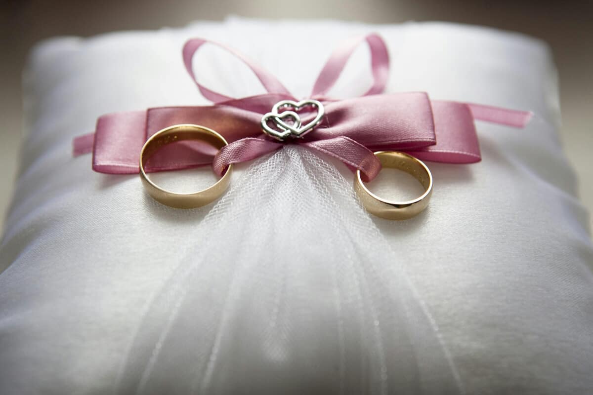 Silver-colored Engagement Ring Set With Pink Bow Accent on Throw Pillow — Pexels