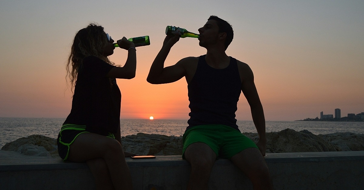 People drinking beer on a beach