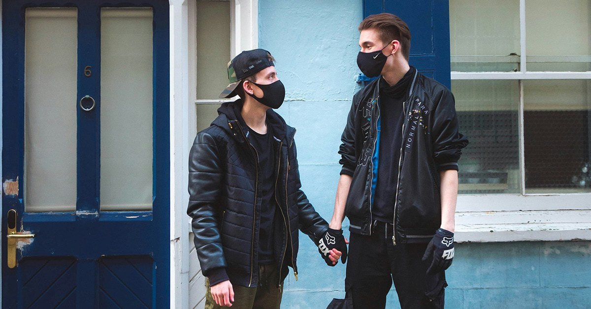Couple wearing face masks holding hands