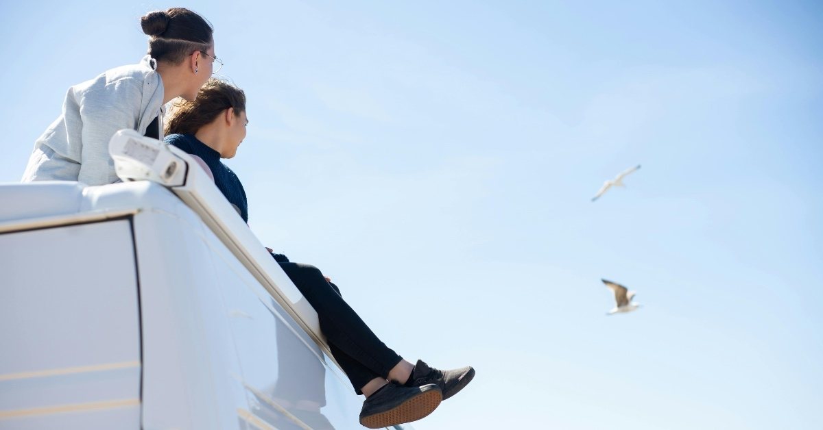 Couple sitting on top of an RV