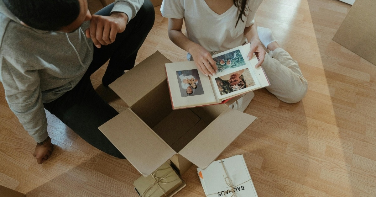 people unpacking photo album
