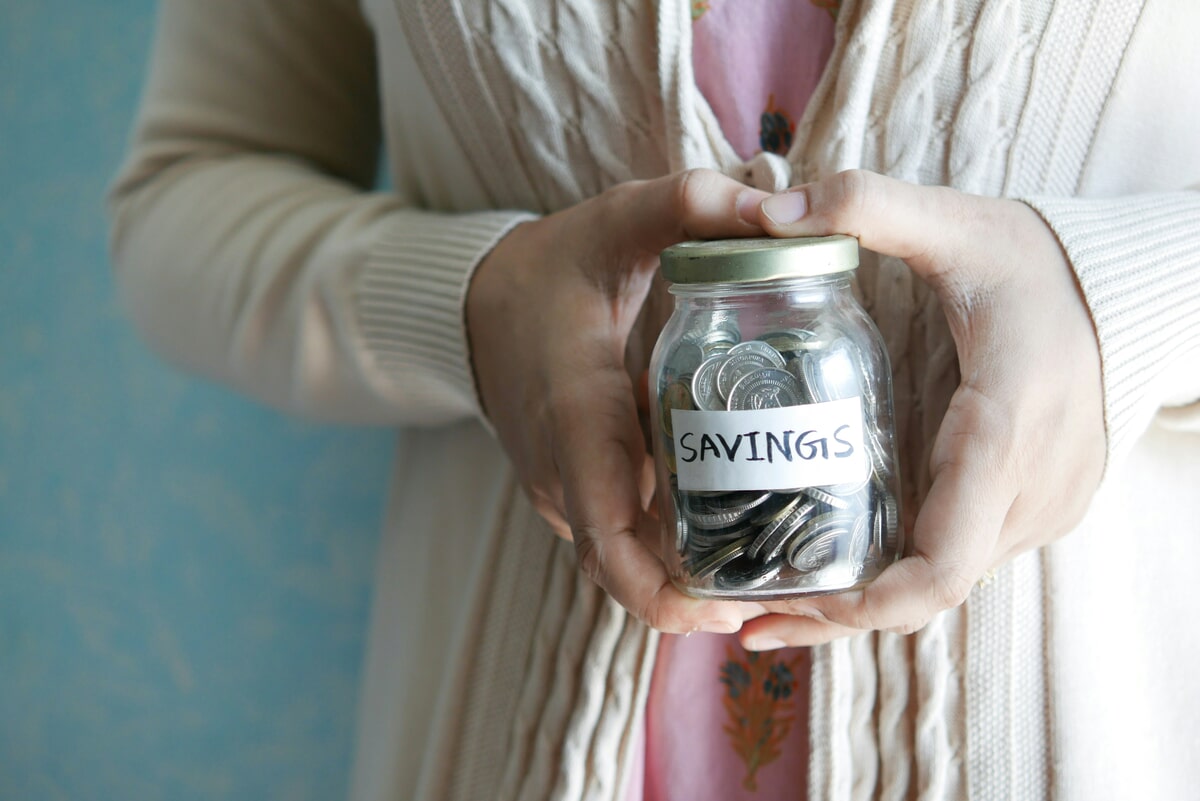 Woman holding savings. towfiqu-barbhuiya-yIIFNiEKkYI-unsplash