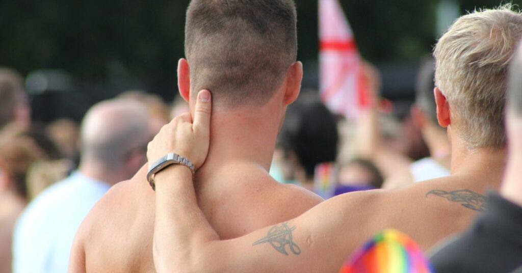 A person with their hand on another person's back.