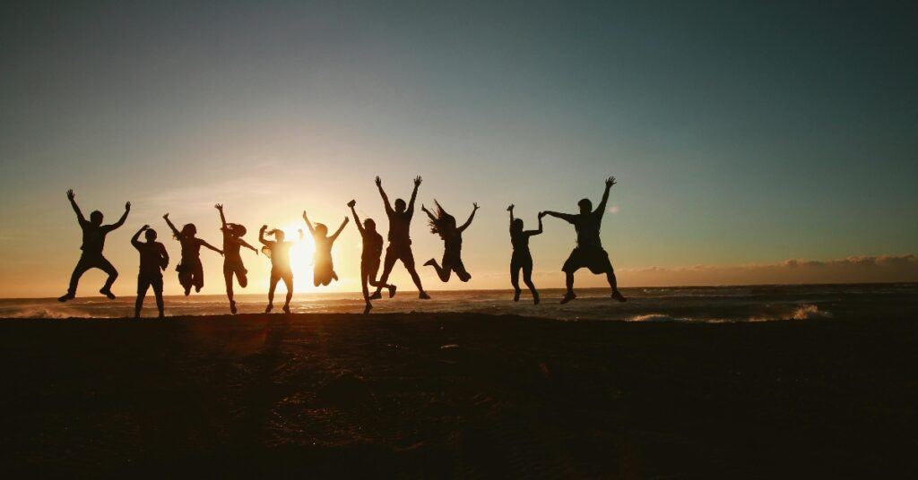 travel group takes pictures at sunset