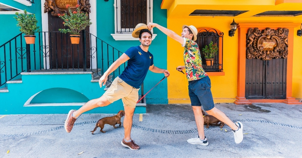 Gay couple takes pictures while walking dog
