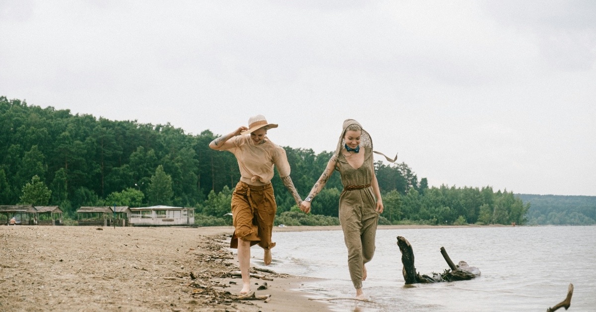 Lesbian couple walks the beach