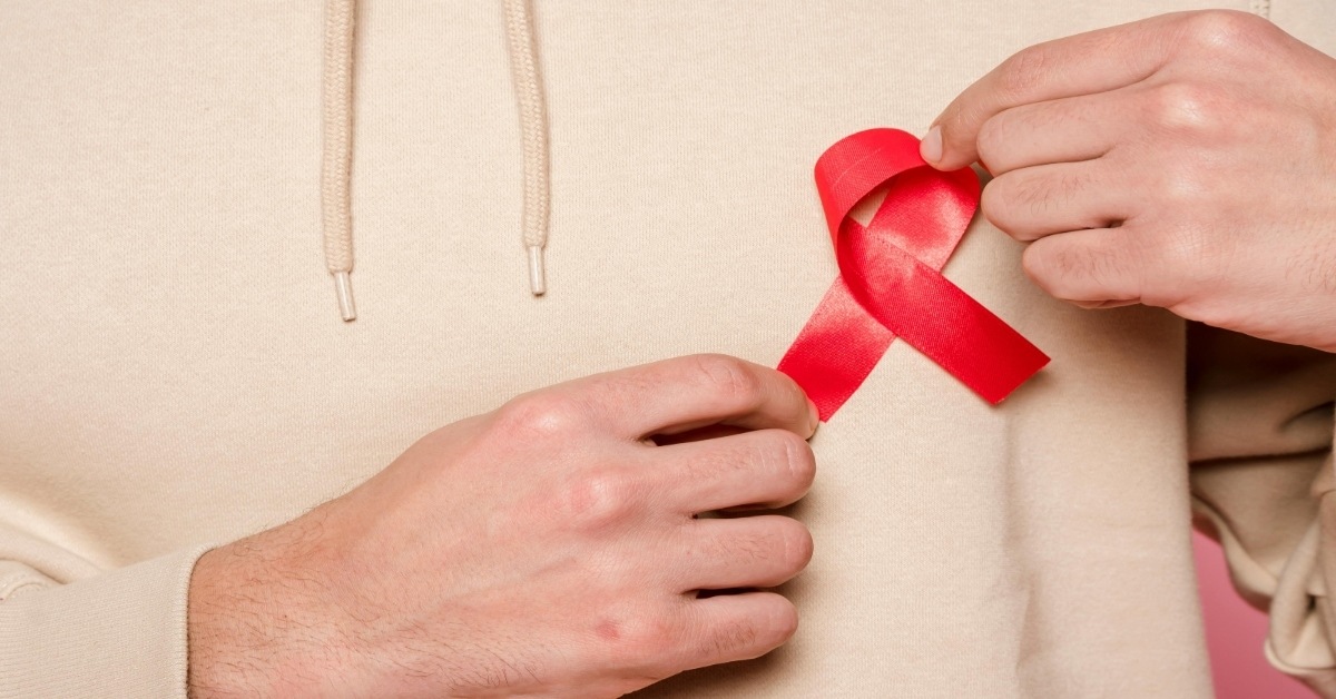 Person holding HIV Ribbon