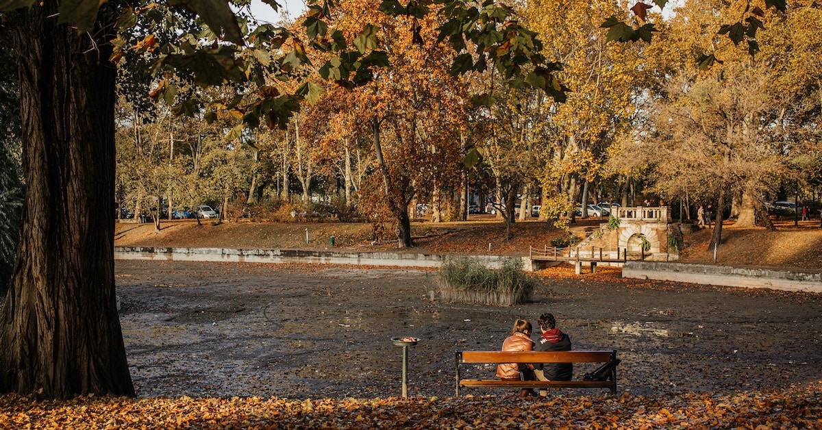 Two people sitting on a bench.