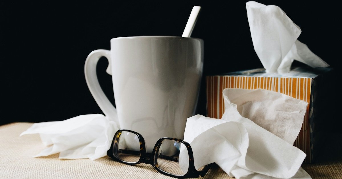 A cup, tissues, and glasses. 