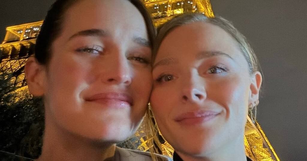 (l-r) Kate Harrison and Chloe Grace Moretz standing close in front of the Eiffel Tower