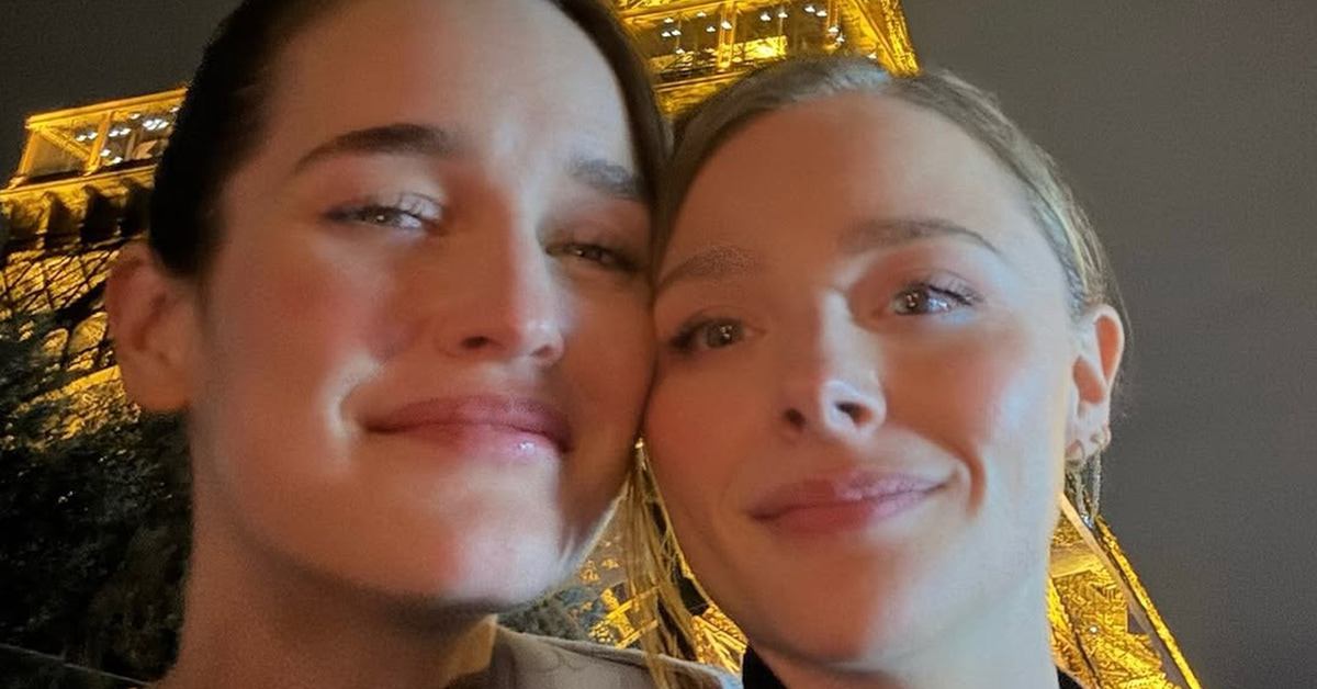 (l-r) Kate Harrison and Chloe Grace Moretz standing close in front of the Eiffel Tower