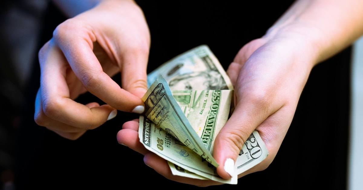 Hands holding money. 