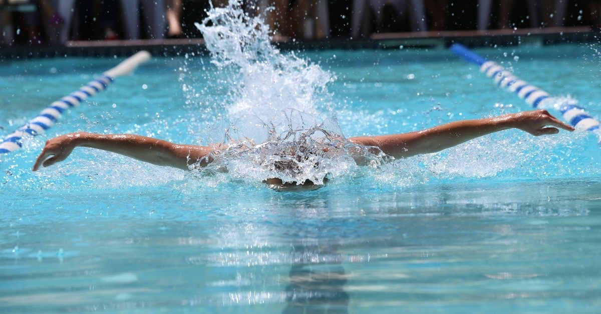 Woman competes as competitive swimmer