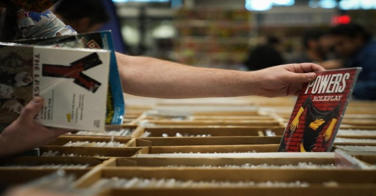 Hand grabbing a book from the shelf