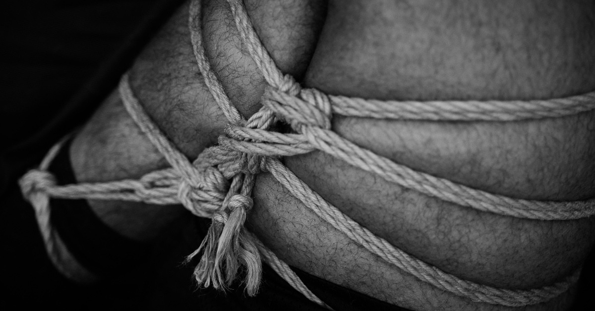black and white photo of male bondage