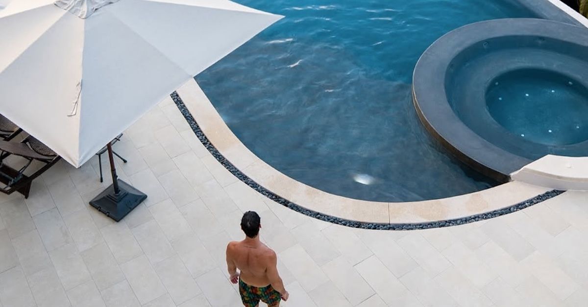 A person standing by a pool.