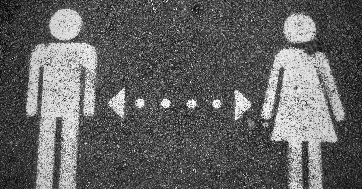 photo of a male symbol and a female symbol painted in white on concrete