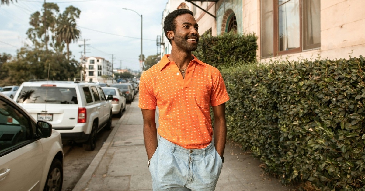 Smiling Man Walking on a Sidewalk