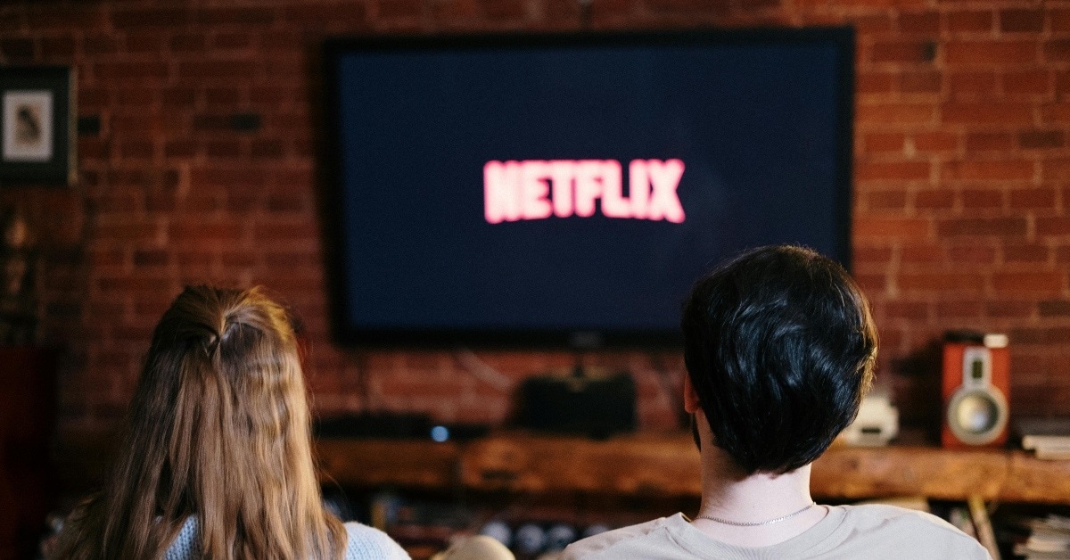 People Sitting on a Couch Watching Netflix
