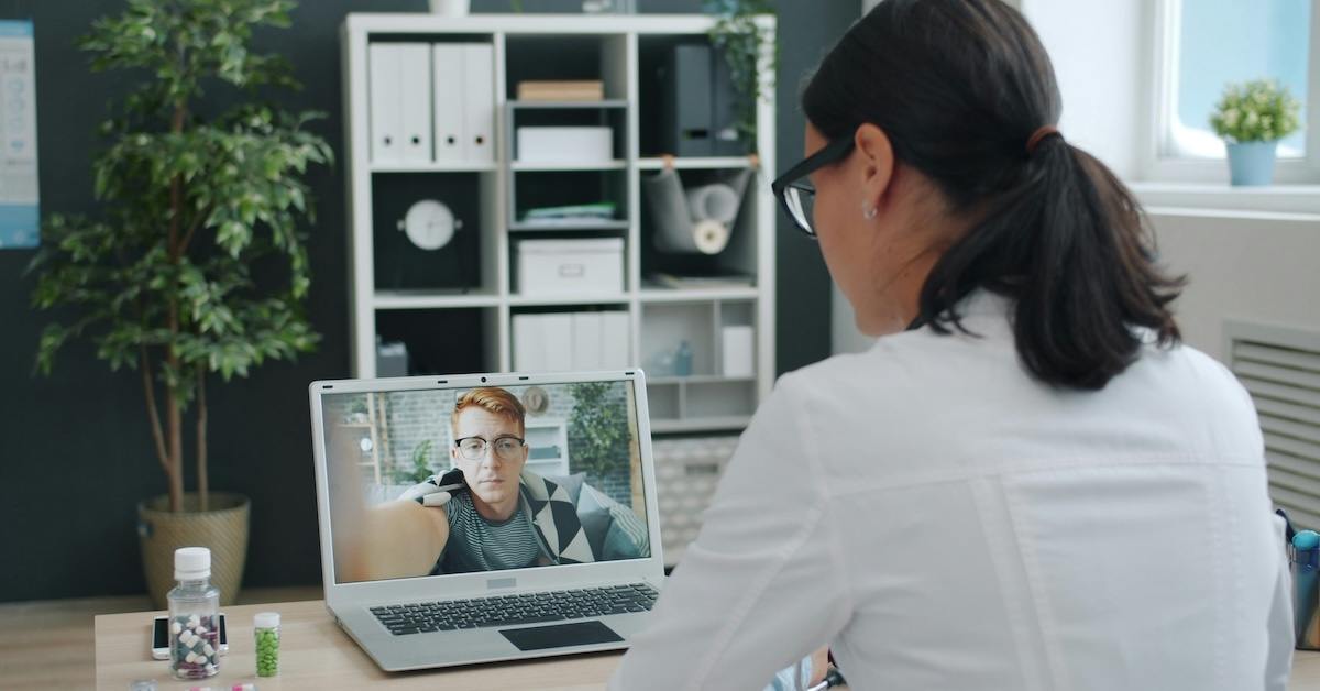A doctor speaking to a patient online.