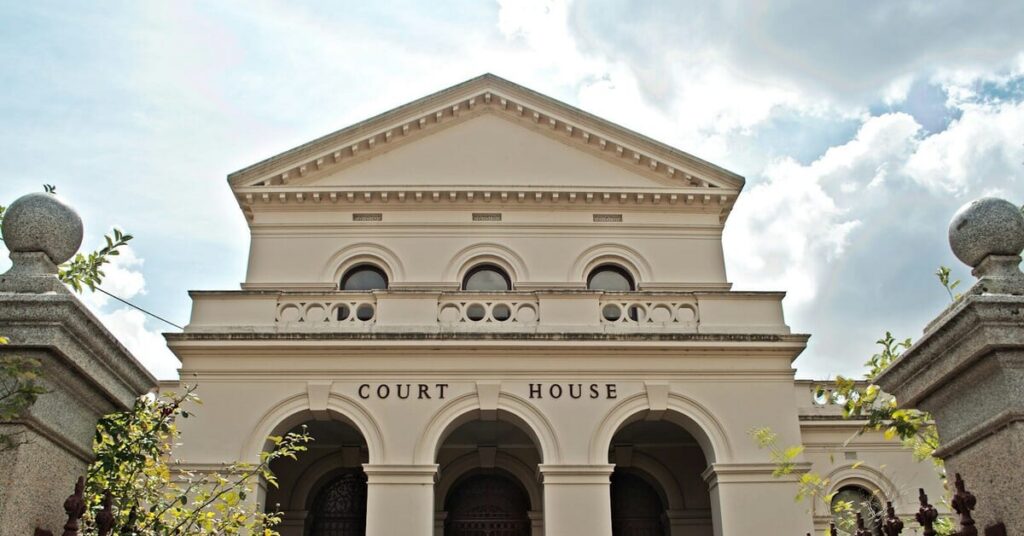 a large white building with a gate in front of it