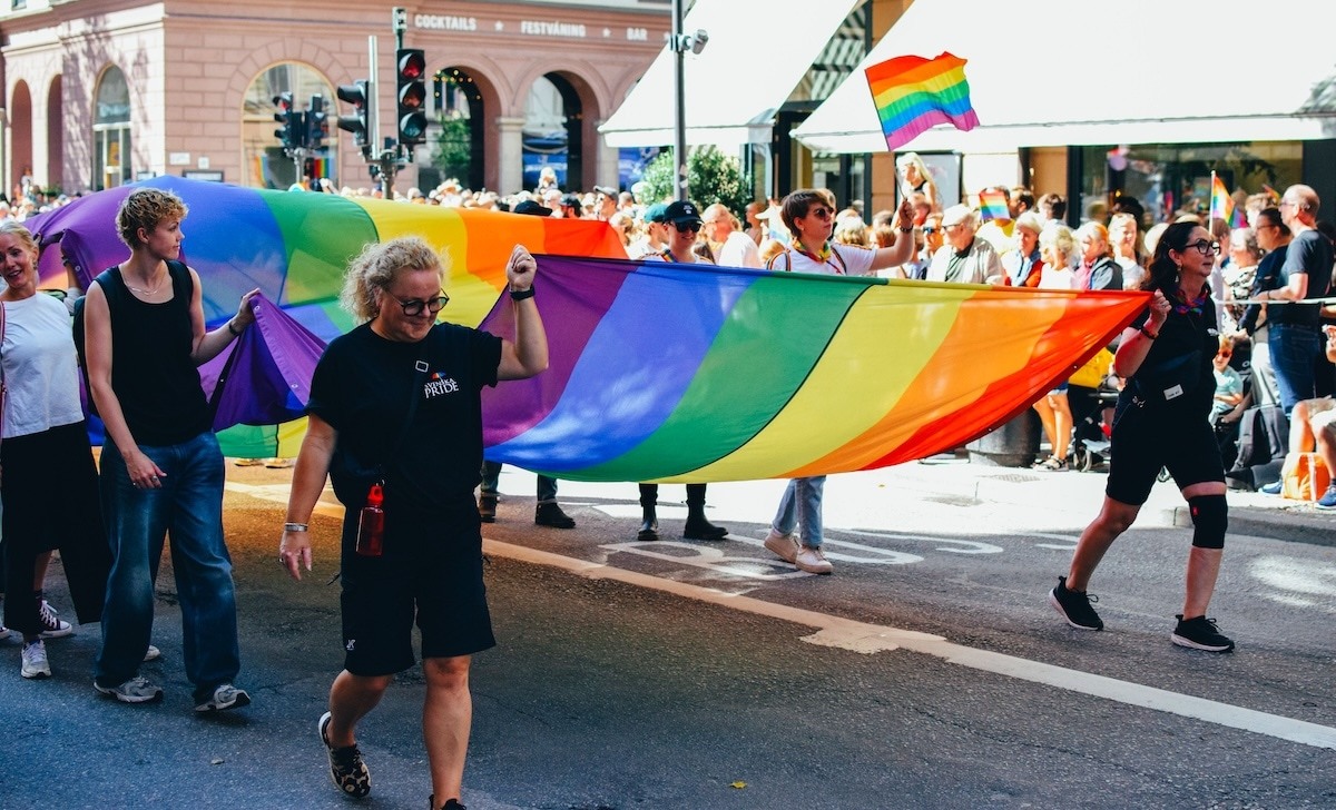 People holding a pride flag.