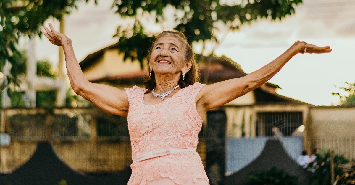 This is a photo of an elderly woman dancing and having fun.