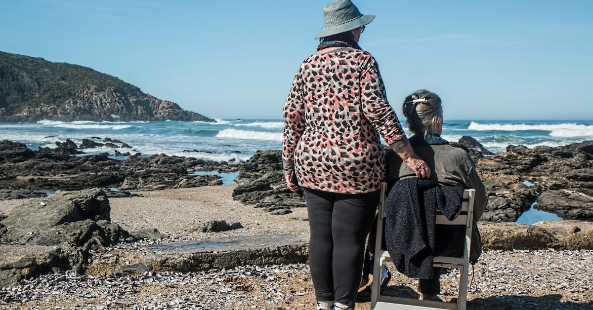 This is a photo of two elderly people looking at the ocean